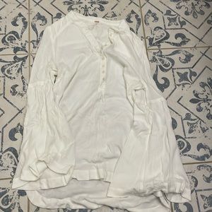 In good condition, white long sleeve with buttons, loose fit.